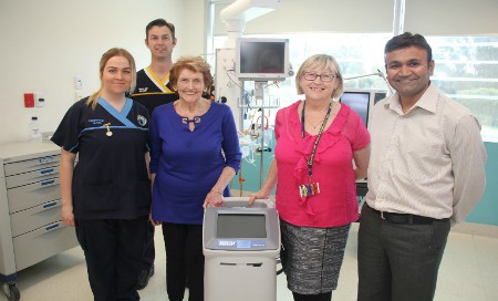 Hospital staff standing beside ICU cooling machine
